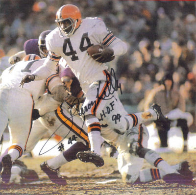 Autographed Photo of Leroy Kelly running with the help of a block by Dick Schafrath